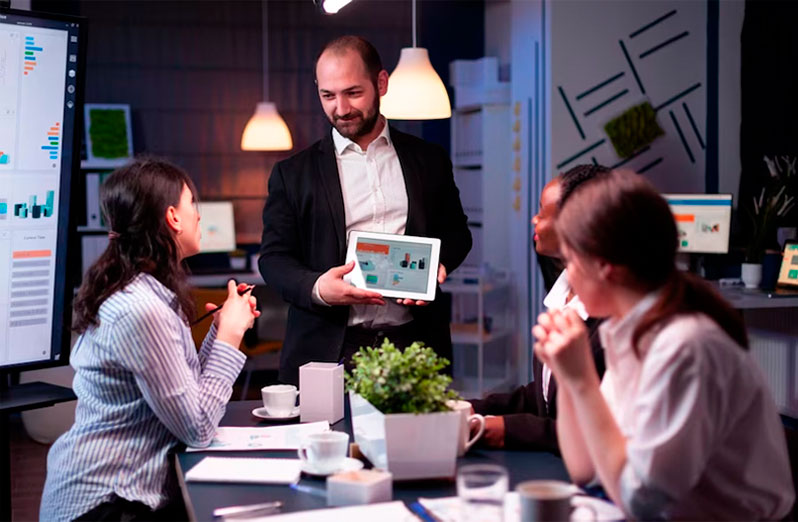 A team of business professionals collaborating in a modern office meeting.